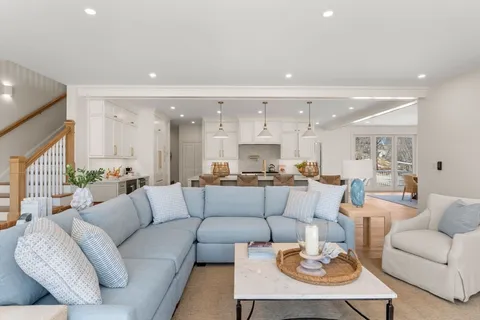 a living room with furniture kitchen view and a table