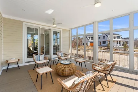 a living room with furniture and large windows