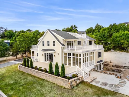 an aerial view of a house with a yard