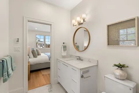 a bathroom with a sink mirror and vanity