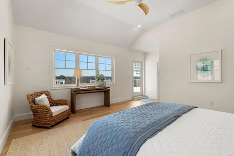 a bedroom with furniture and a kitchen