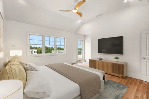 a bedroom with a bed and a flat screen tv