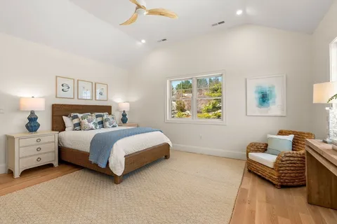 a spacious bedroom with a bed and a couch