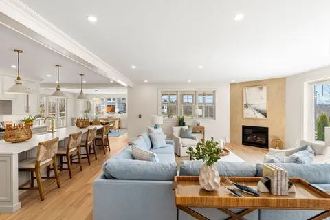 a living room with furniture fireplace and a fireplace
