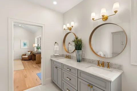a bathroom with a double vanity sink and a mirror