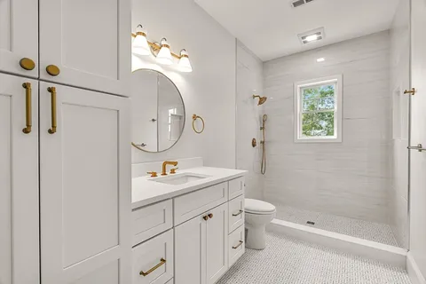 a bathroom with a toilet a sink a mirror a shower a and a window