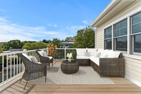 a view of a deck with couches table and chairs