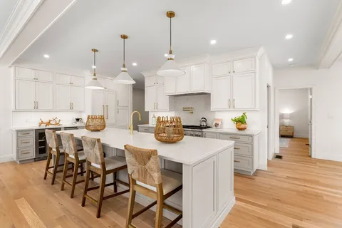 a kitchen with stainless steel appliances kitchen island granite countertop a sink and cabinets