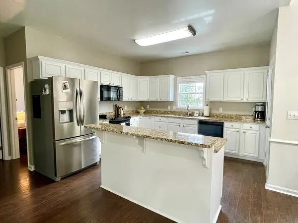 a kitchen with stainless steel appliances a refrigerator and a stove top oven