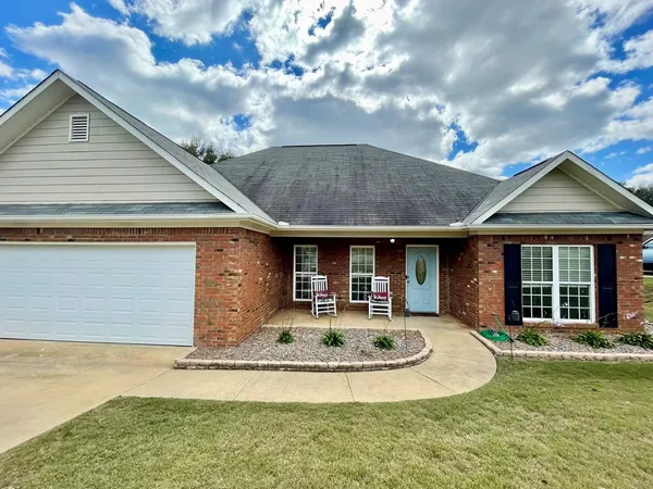 a front view of a house with a yard garage and outdoor seating