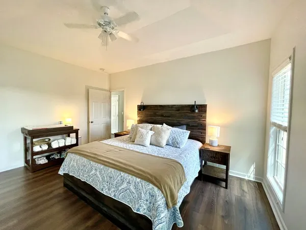 a bedroom with a bed a dresser and a window