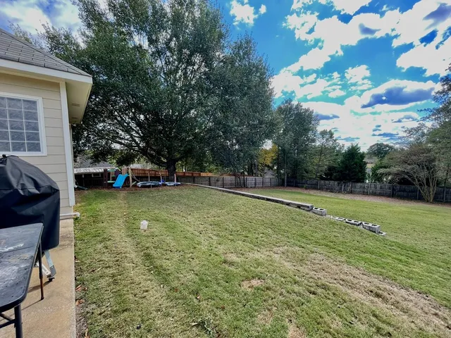 a view of a swimming pool with a patio