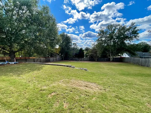 a view of a swimming pool with a yard