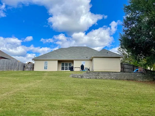 a house with huge green field in front of it