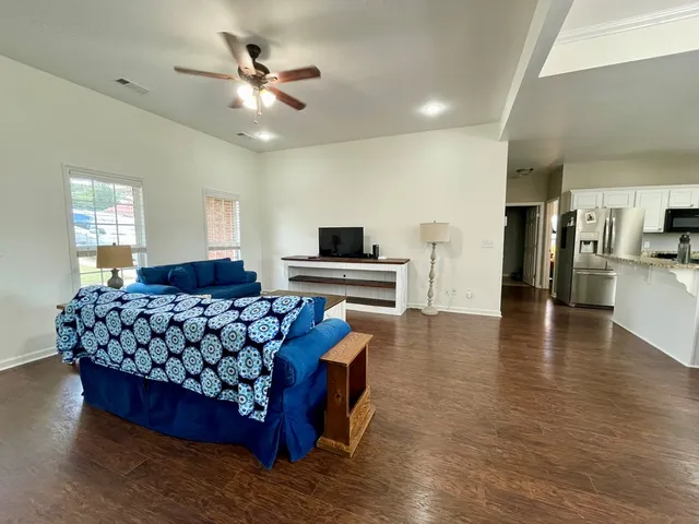 a living room with furniture and wooden floor