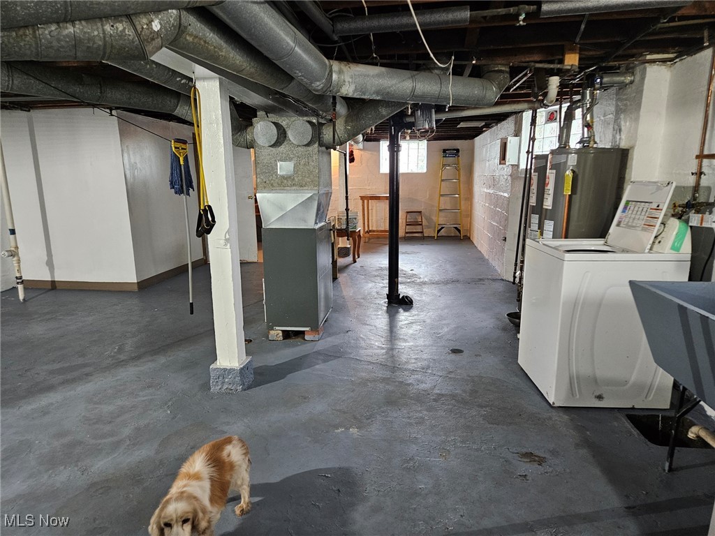2538 Scranton Road Cleveland, OH 44113 - Photo 22 of 27 Basement with water heater, sink, and washer / dryer