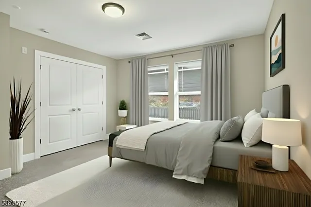 a living room with furniture a flat screen tv and a window