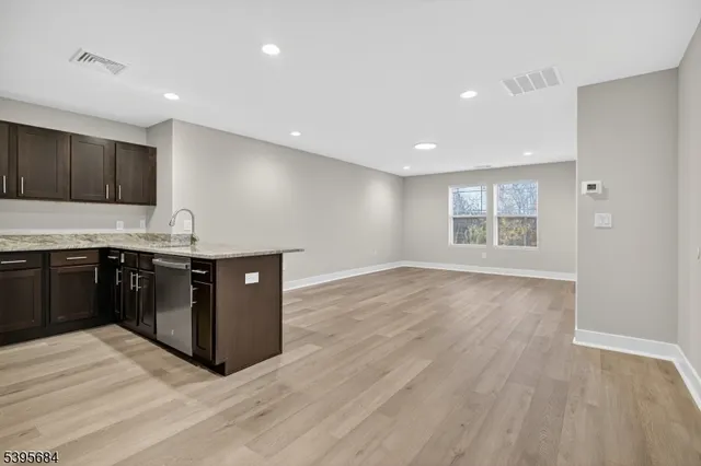 a kitchen with stainless steel appliances granite countertop a stove and a wooden cabinets