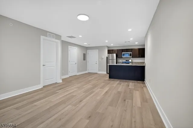 a view of a kitchen with a sink and wooden floor