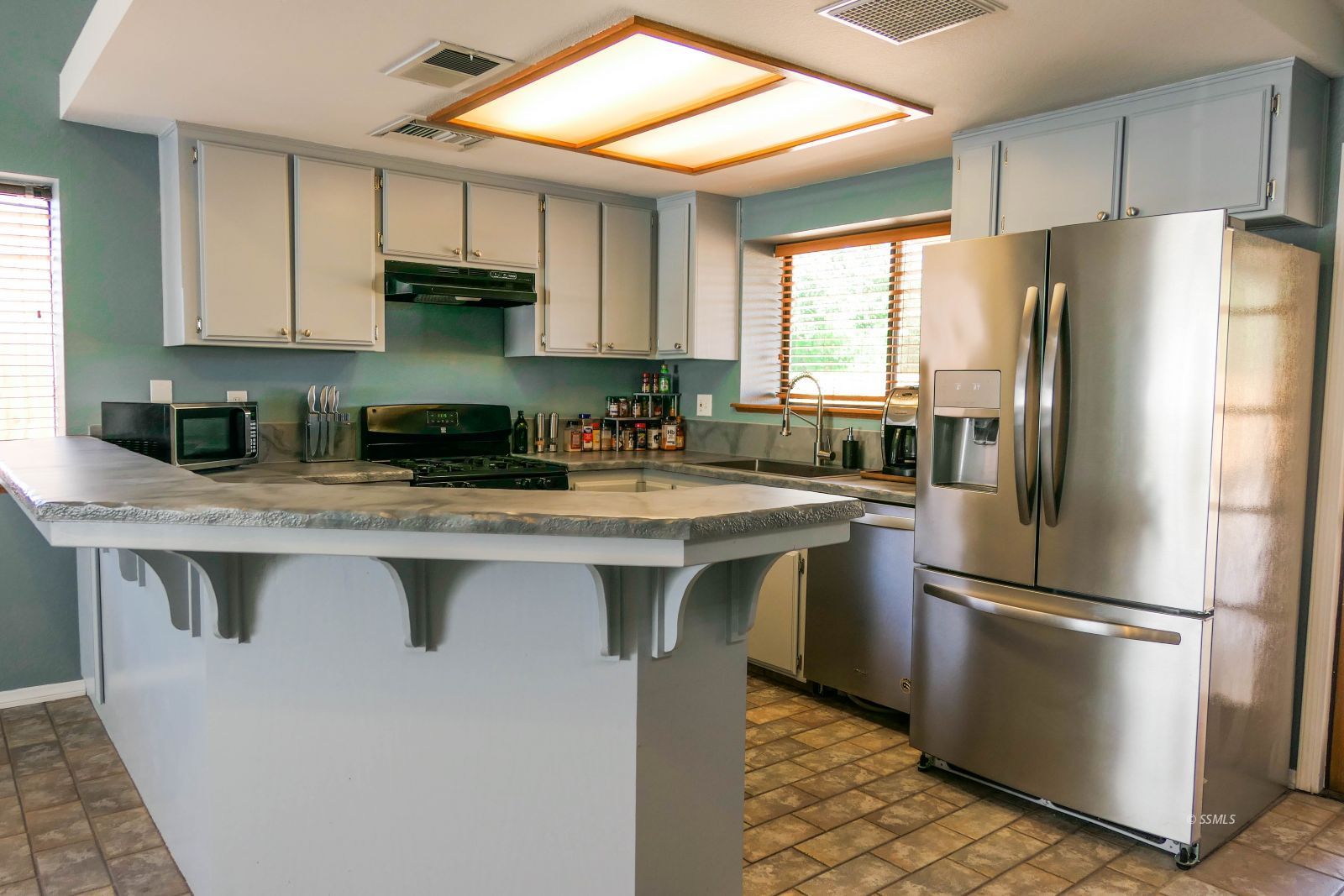 601 Heather Court Ridgecrest, CA 93555 - Photo 8 of 45 a kitchen with stainless steel appliances granite countertop a refrigerator a sink a stove and white cabinets