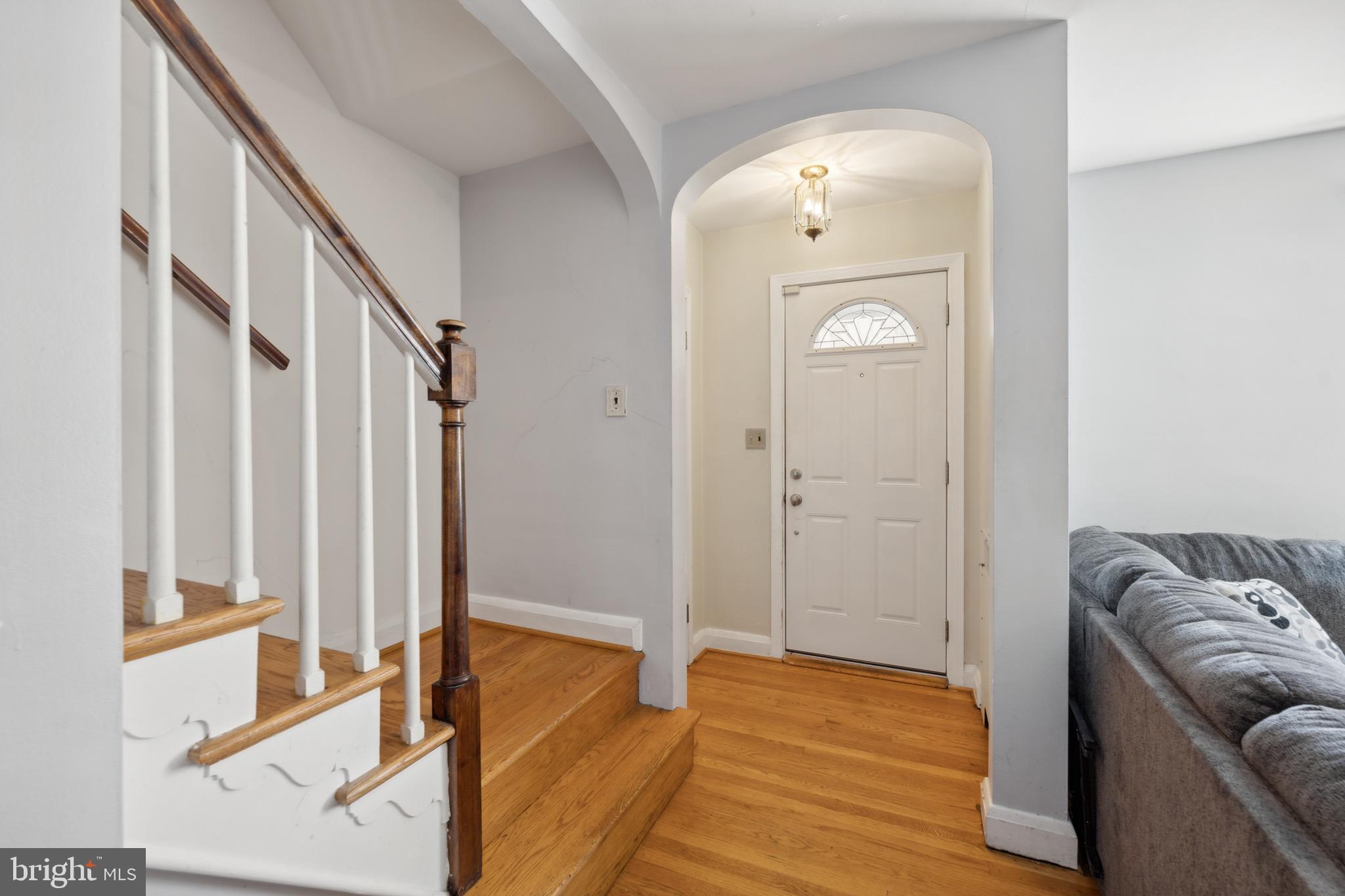 411 Overbrook Road Catonsville, MD 21228 - Photo 3 of 19 a view of a hallway with wooden floor and staircase