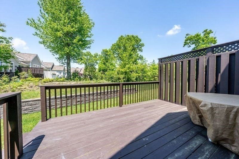 45 Grey Hawk Drive, Unit 45 Mashpee, MA 02649 - Photo 16 of 21 a balcony with wooden floor and fence