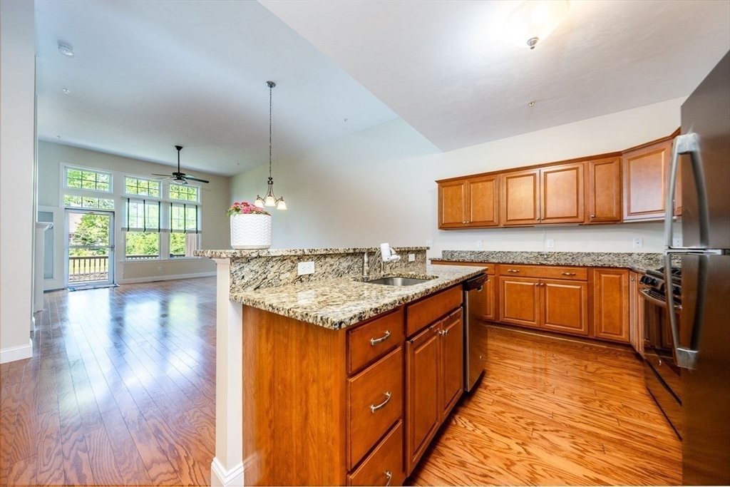 45 Grey Hawk Drive, Unit 45 Mashpee, MA 02649 - Photo 5 of 21 a kitchen with a stove top oven sink and cabinets