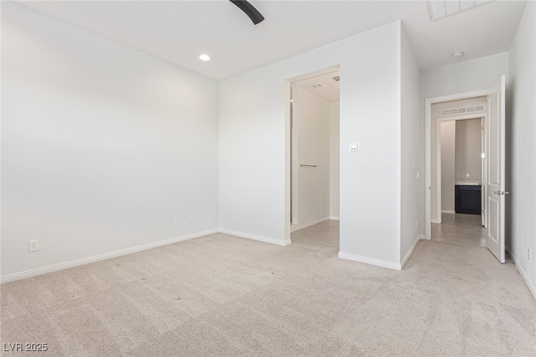 298 Nine Mile Creek Drive Las Vegas, NV 89138 - Photo 10 of 30 Unfurnished bedroom featuring light carpet, ceiling fan, and recessed lighting