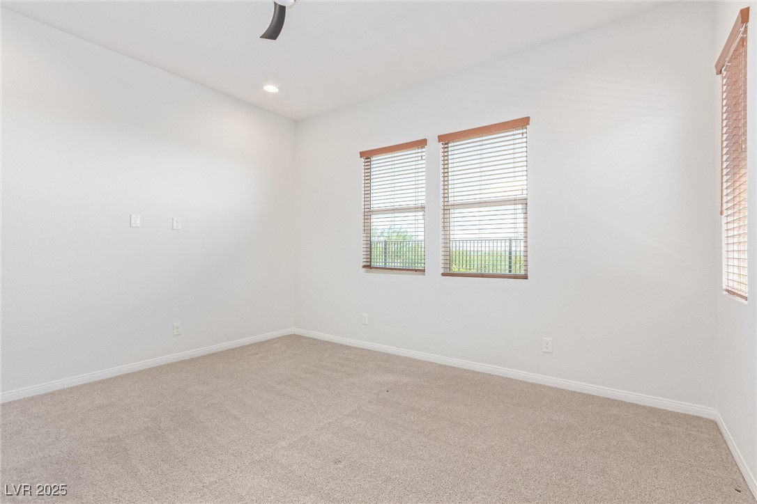 298 Nine Mile Creek Drive Las Vegas, NV 89138 - Photo 16 of 30 Empty room with light colored carpet, recessed lighting, and ceiling fan