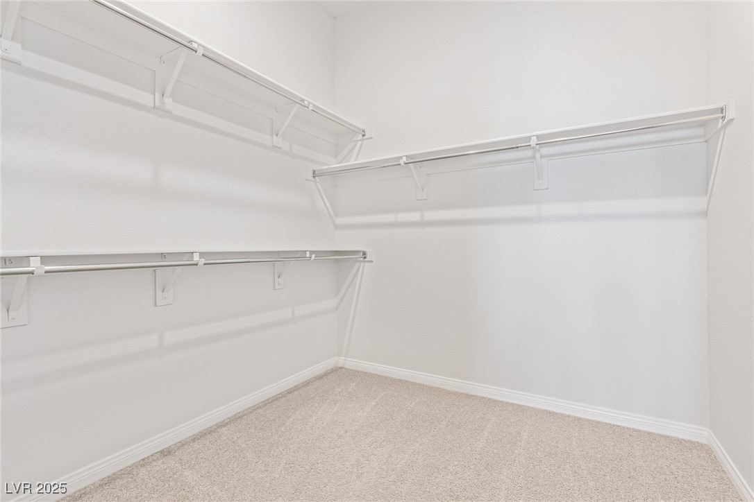 298 Nine Mile Creek Drive Las Vegas, NV 89138 - Photo 17 of 30 Walk in closet featuring light carpet