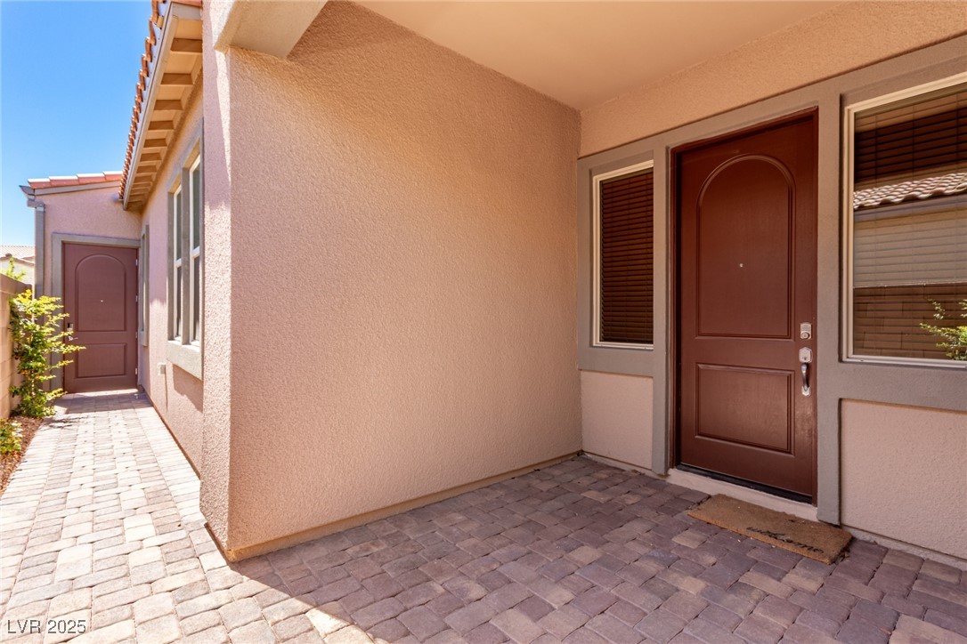 298 Nine Mile Creek Drive Las Vegas, NV 89138 - Photo 2 of 30 View of exterior entry featuring stucco siding