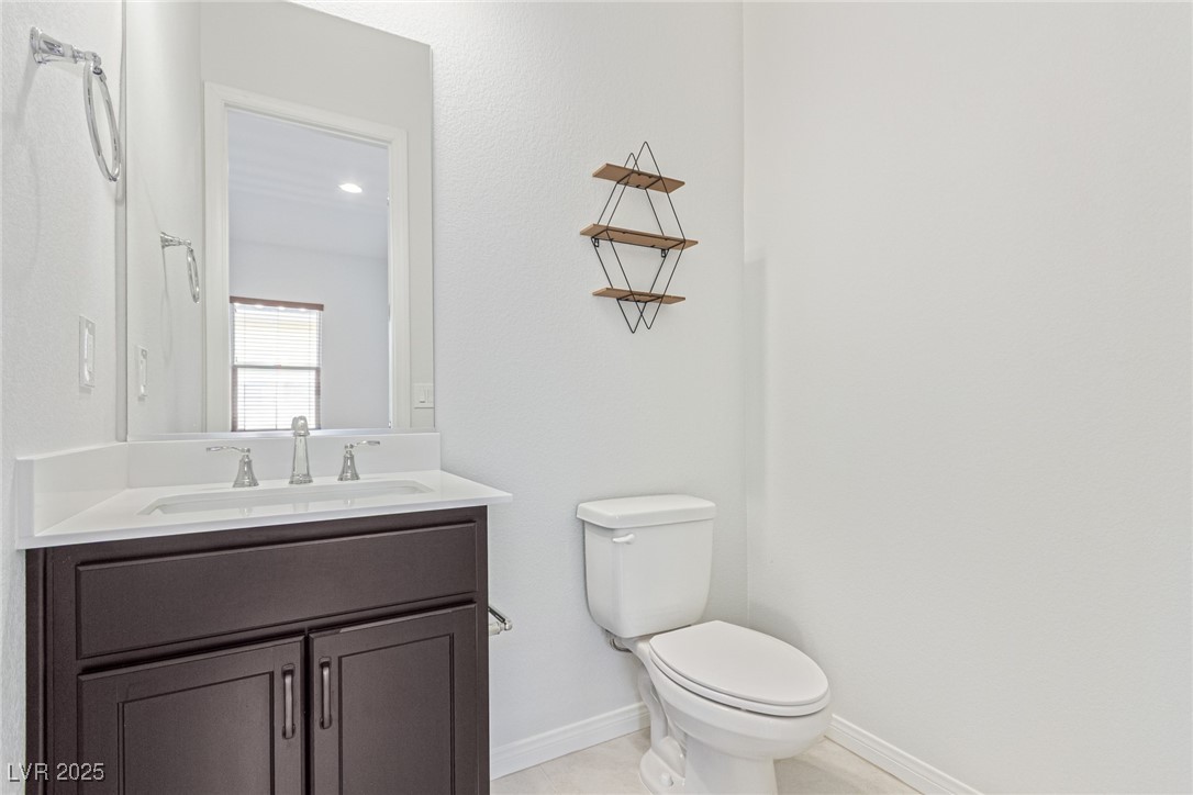 298 Nine Mile Creek Drive Las Vegas, NV 89138 - Photo 20 of 30 Half bath with vanity and light tile patterned flooring