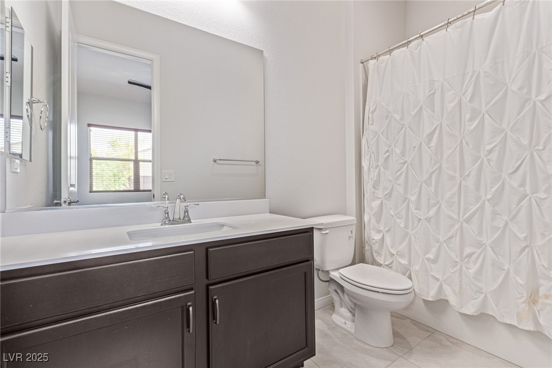 298 Nine Mile Creek Drive Las Vegas, NV 89138 - Photo 23 of 30 Full bathroom featuring vanity, light tile patterned floors, and shower / bath combo