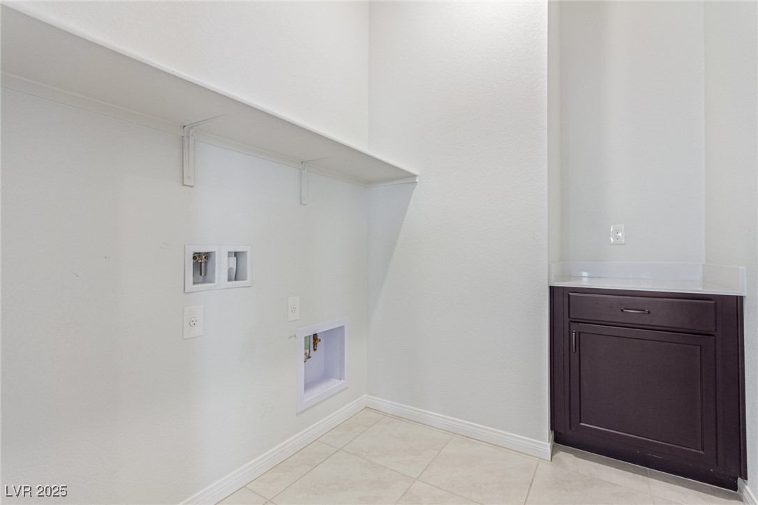 298 Nine Mile Creek Drive Las Vegas, NV 89138 - Photo 24 of 30 Washroom with light tile patterned flooring and hookup for a washing machine