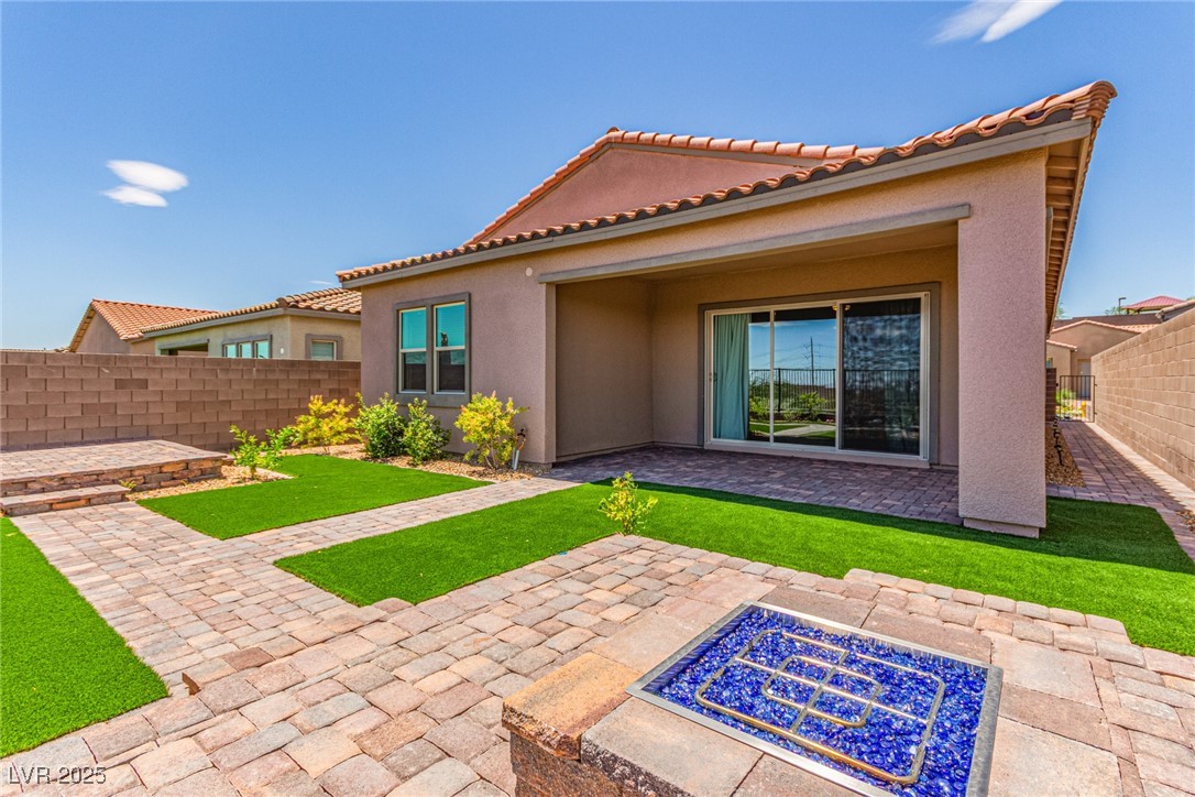 298 Nine Mile Creek Drive Las Vegas, NV 89138 - Photo 27 of 30 Rear view of house featuring a fenced backyard, a patio, stucco siding, and a tiled roof