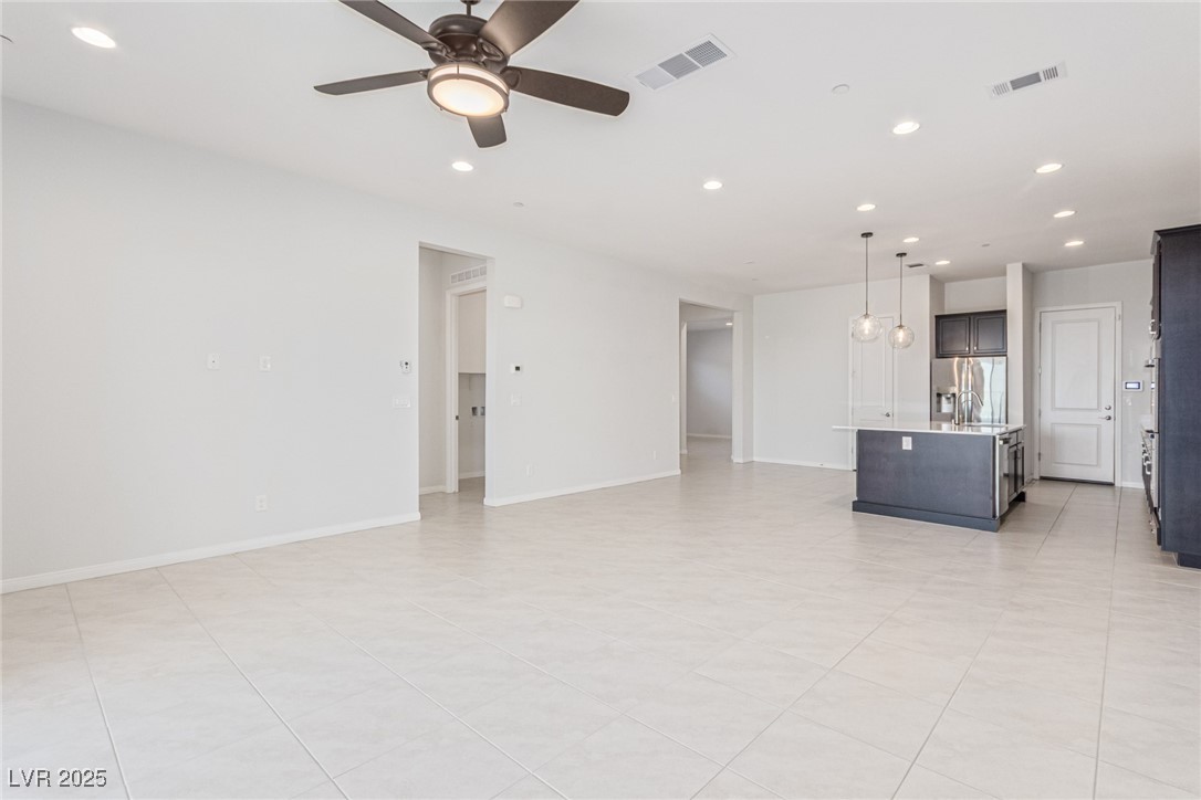 298 Nine Mile Creek Drive Las Vegas, NV 89138 - Photo 5 of 30 Unfurnished living room featuring recessed lighting, light tile patterned floors, and a ceiling fan