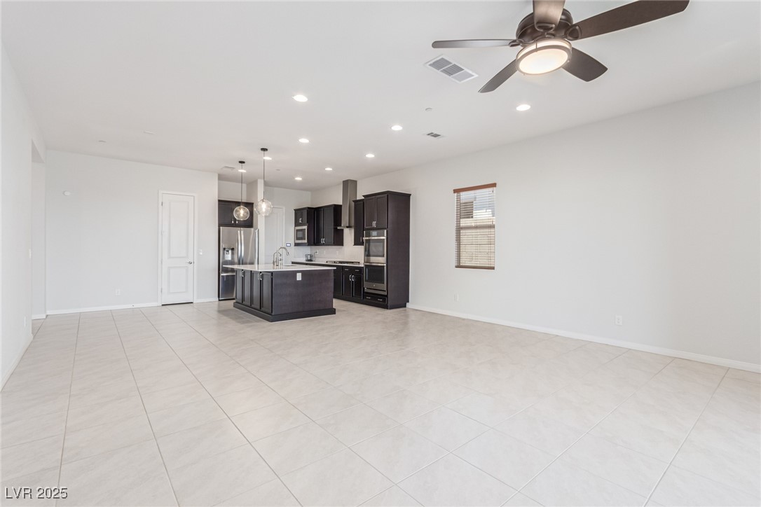 298 Nine Mile Creek Drive Las Vegas, NV 89138 - Photo 30 of 30 Kitchen with open floor plan, light countertops, recessed lighting, a kitchen island with sink, and light tile patterned floors