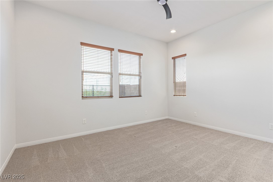 298 Nine Mile Creek Drive Las Vegas, NV 89138 - Photo 9 of 30 Spare room with light carpet, recessed lighting, and a ceiling fan