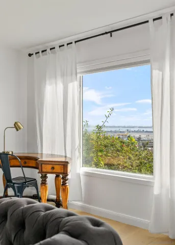a view of a hallway with wooden floor and closet