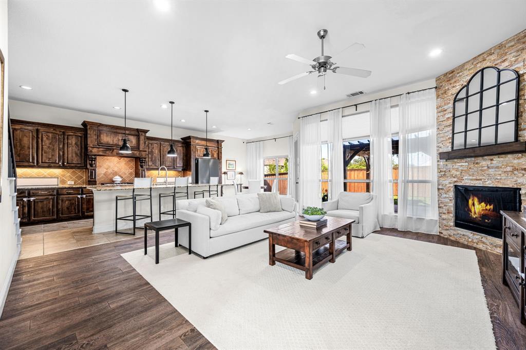 8 Center Court Heath, TX 75032 - Photo 11 of 34 a living room with furniture and a fireplace