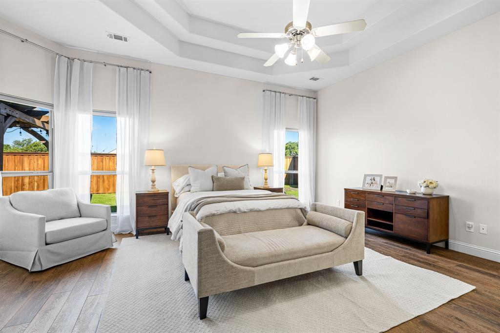 8 Center Court Heath, TX 75032 - Photo 18 of 34 a bedroom with furniture and a couch