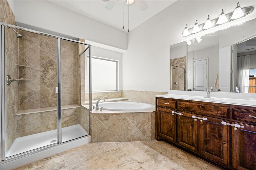 8 Center Court Heath, TX 75032 - Photo 20 of 34 a spacious bathroom with a tub sink shower and mirror