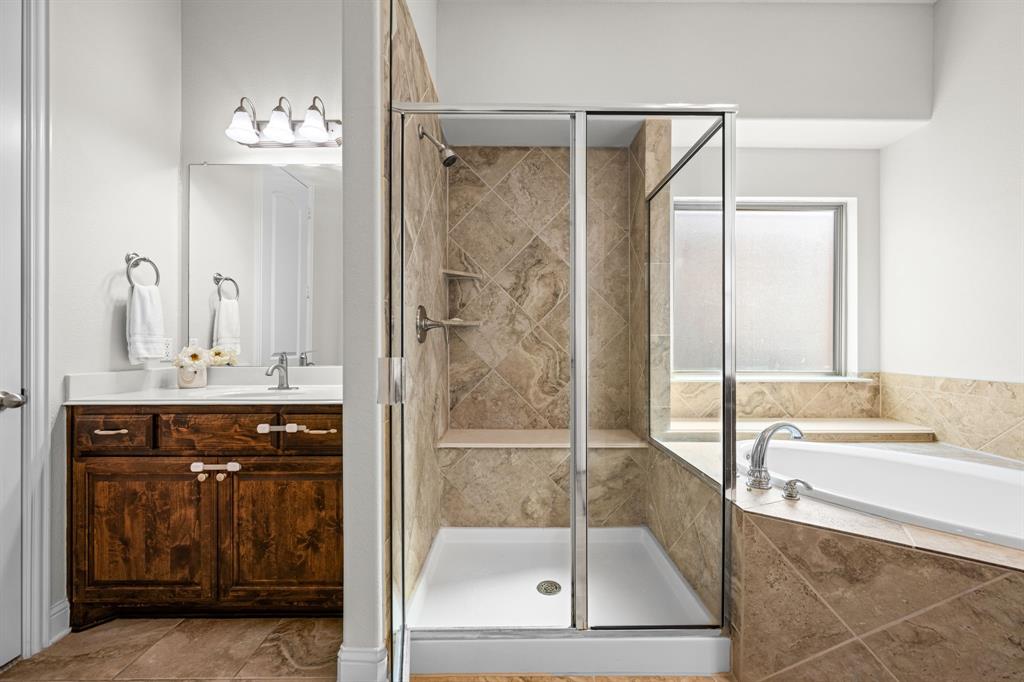 8 Center Court Heath, TX 75032 - Photo 21 of 34 a bathroom with a bathtub shower sink and mirror