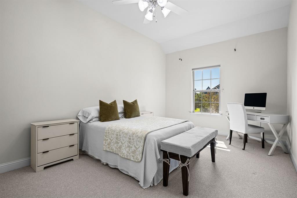 8 Center Court Heath, TX 75032 - Photo 23 of 34 a bedroom with a bed and a chandelier