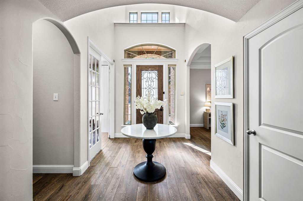 8 Center Court Heath, TX 75032 - Photo 6 of 34 a view of a hallway with wooden floor windows and a chandelier