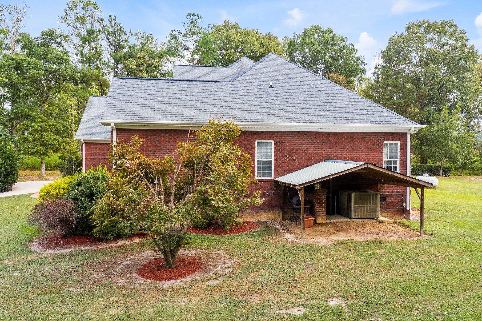 525 Eatmon Road Zebulon, NC 27597 - Photo 27 of 30 Around the left hand side of the house, storage overhang or can be used as outdoor entertainment space. Exterior Back