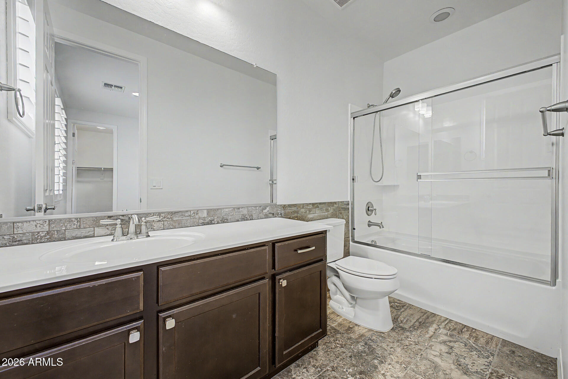 1076 East Kensington Road Gilbert, AZ 85297 - Photo 28 of 73 a bathroom with a granite countertop sink toilet and shower