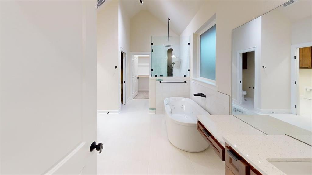 2509 Windmill Lane Longview, TX 75601 - Photo 17 of 35 Full bath featuring a jetted tub, walk in shower, vanity, vaulted ceiling, and tile patterned floors