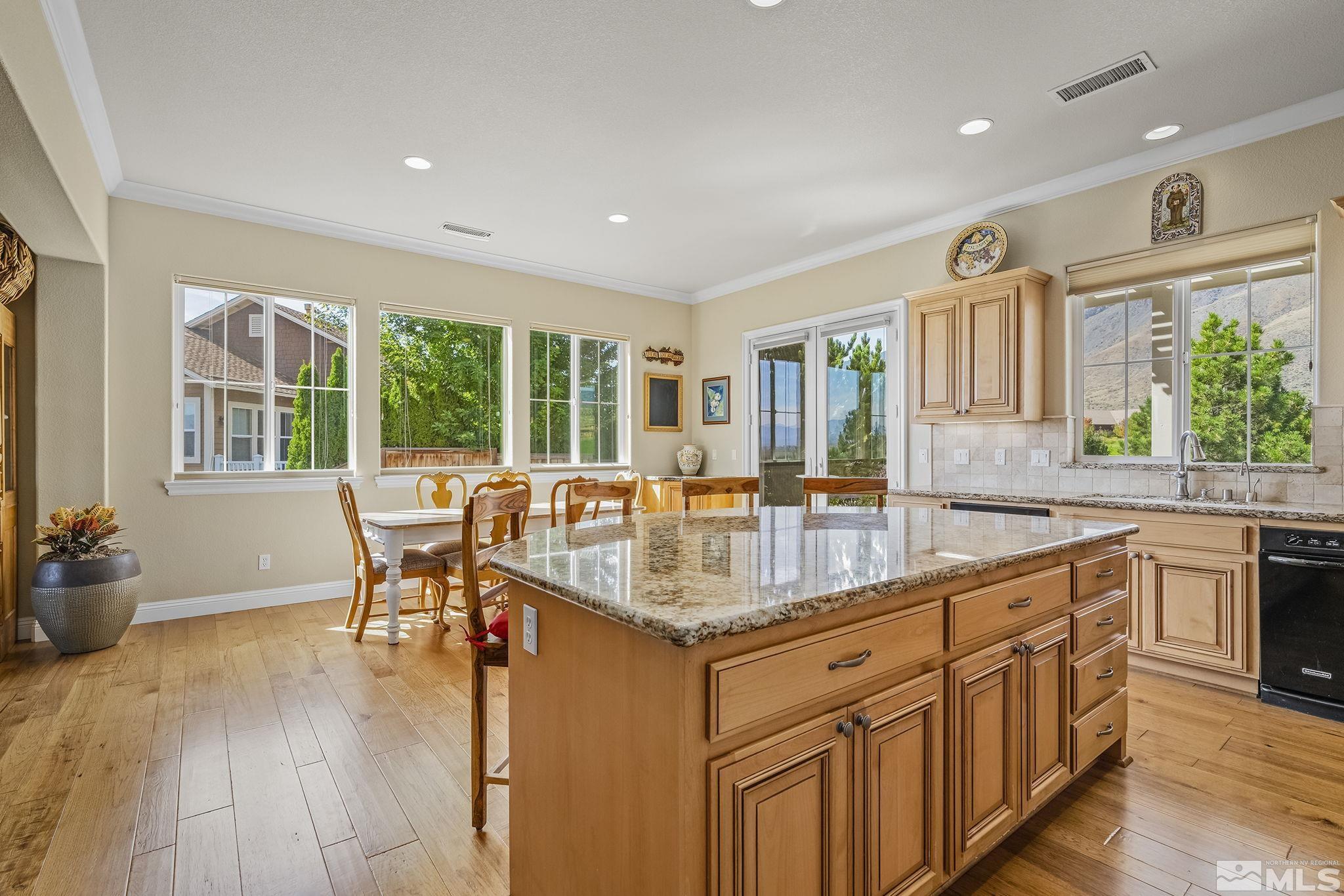 2892 Promontory Drive Genoa, NV 89411 - Photo 12 of 40 a kitchen with stainless steel appliances granite countertop a stove and a sink