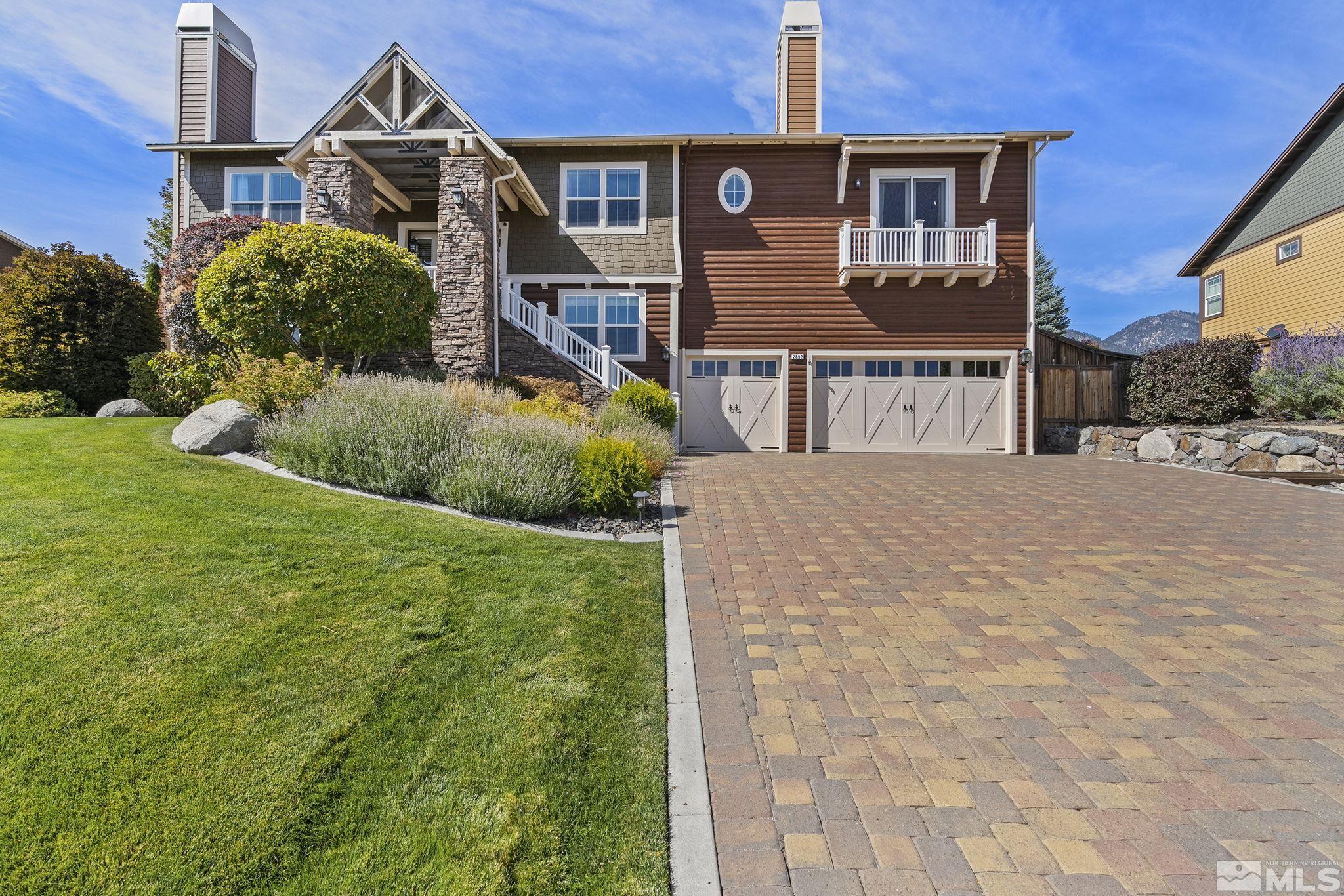 2892 Promontory Drive Genoa, NV 89411 - Photo 2 of 40 a front view of a house with garden